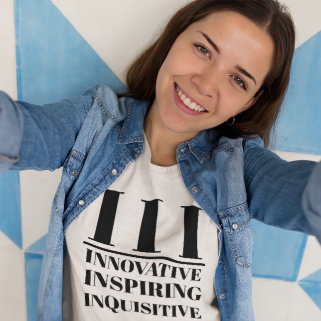 III- Innovative, Inspiring, Inquisitive T-Shirt (Young woman wears a "III: Innovative, Inspiring, Inquisitive" white t-shirt.)