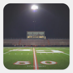 Illuminated American football field at night Square Sticker