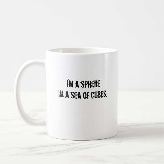 I'm a spherein a sea of cubes. coffee mug (Left)