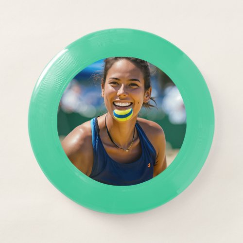 Image of a beach tennis player panting but smiling Wham_O frisbee