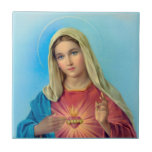 Immaculate Heart of Mary Ceramic Tile<br><div class="desc">This is a lovely ceramic tile featuring the Immaculate Heart of Mary pictures with a delicate gold frame. The beautiful Virgin Mary wears blue and red robes and points to her immaculate heart with one hand while holding the other hand upwards towards the heavens. Set against a blue background. This...</div>