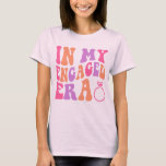 In my Engaged Era, Engagement  T-Shirt<br><div class="desc">The "In my Engaged Era" design celebrates the joy and excitement of being engaged to a partner. This design embodies the unique stage of life where two individuals have made a commitment to spend their lives together. With its elegant and captivating typography, the design showcases the love and anticipation that...</div>