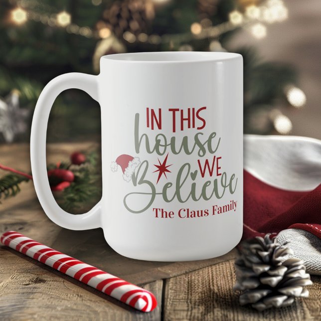 In This House We Believe Cute Custom Christmas Coffee Mug (In This House We Believe Cute Custom Christmas Coffee Mug. Just add your family name!)