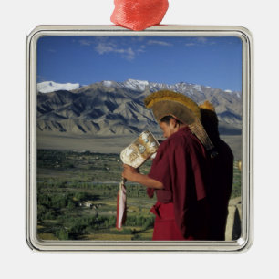 India, Ladakh, Thikse. Buddhist monk blows Metal Ornament