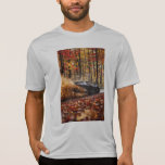 Inferno Run – Black Velocity Through Autumn Flame T-Shirt<br><div class="desc">A matte black sports car rips through a dense autumn forest, its engine screaming as it carves impossible lines between towering trees. A storm of golden, crimson, and fiery orange leaves erupts in its wake, caught in a chaotic dance of speed and color. The camera hugs tight behind, dipping and...</div>