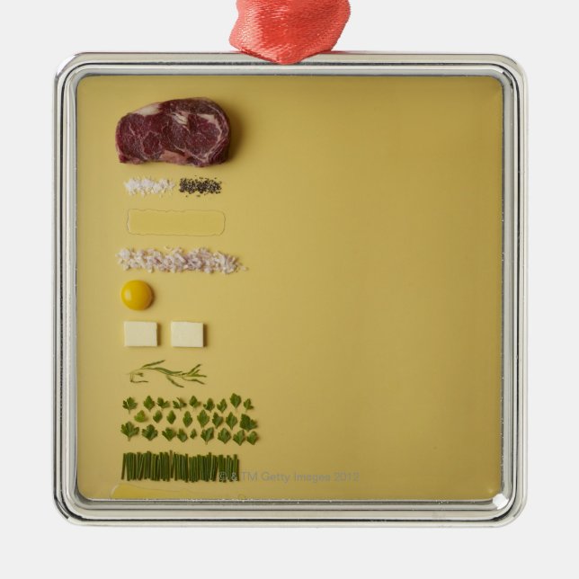 Ingredients for steak tartare on yellow metal ornament (Front)