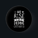 Inspirational Quote We Rise By Lifting Others Button<br><div class="desc">Inspirational motivation quote to keep you inspired and motivate others around you.

Beautiful saying about being kind,  supportive and helping each other. We rise by lifting others.

Background color can be customized to your desired color.</div>