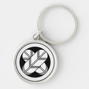 Intersecting hawk feathers in circle keychain