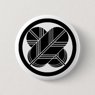 Intersecting hawk feathers with foot in circle button