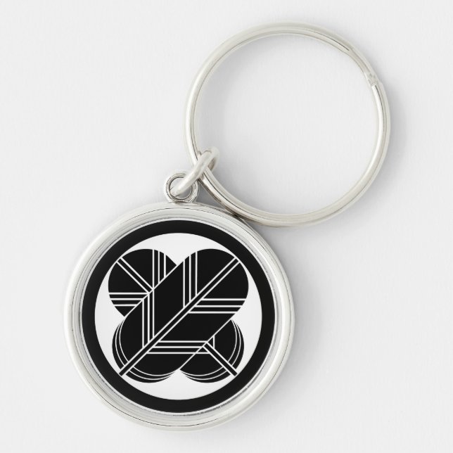 Intersecting hawk feathers with foot in circle keychain (Front)