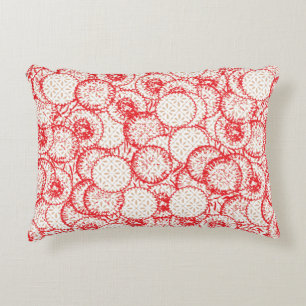 Intricate textile design featuring red, gold, and accent pillow