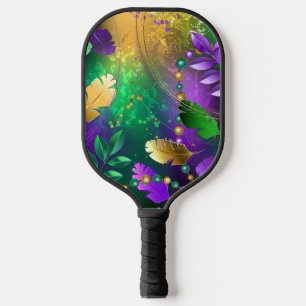 Iridescent mardi gras background with beads carbon fiber pickleball paddle