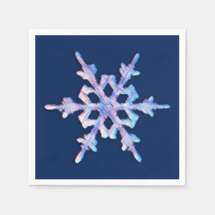 Iridescent snowflake on dark blue paper napkins