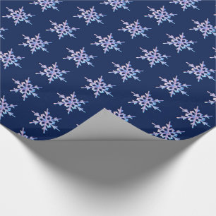 Iridescent snowflake on dark blue wrapping paper