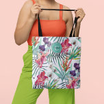 Island Style Tropical Floral Pattern and Monogram Tote Bag<br><div class="desc">In vibrant island style, this tropical themed tote has a colorful pattern of exotic orchids, lilies and parrot flowers with scattered palm fronds and foliage over a contrasting white background. An aqua round frame placed at the top of the bag includes a text template for personalizing with your desired name...</div>