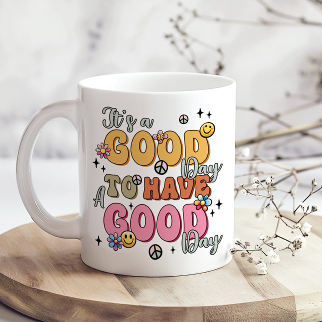 It’s a Good Day to Have a Good Day Retro Groovy Coffee Mug (Retro Positivity "It's a Good Day" Coffee Mug on a boho table with tiny dry white flowers)