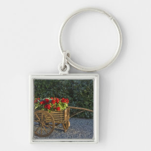 Italy, Tuscany. Red geraniums spill out of an Keychain
