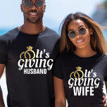 It's Giving Husband Just Married Honeymoon Wedding T-Shirt<br><div class="desc">Black white and gold "It's giving husband" shirt for a groom.  Great for a bachelorette party,  honeymoon,  anniversary or everyday wear for a proud spouse.  Personalize it with your last name or change colors.</div>