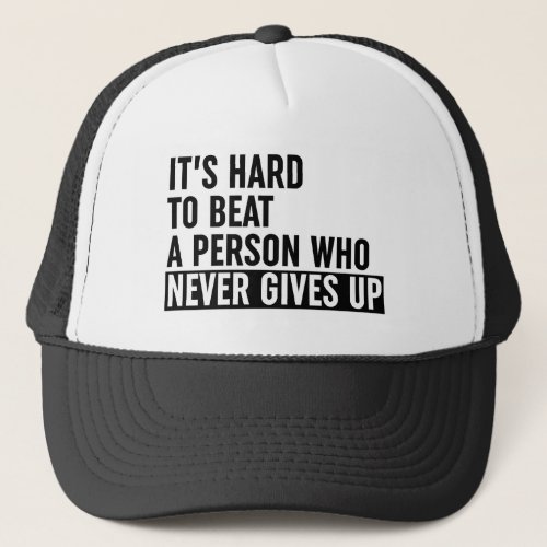Its Hard To Beat A Person Who Never Gives Up Trucker Hat