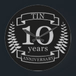 Ivory Traditional wedding anniversary 10 years Large Clock<br><div class="desc">A design to celebrate 10 years of marriage. This design has a Grey / silver (the traditional color for this anniversary) colored laurel design on a black background. Tin is the traditional gift for this occasion. The text reads Tin 10 years anniversary. A romantic design to celebrate your 10th year...</div>