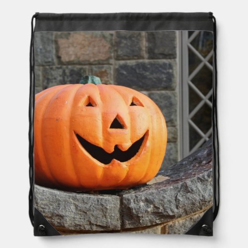 Jack_o_lantern on a stone wall drawstring bag