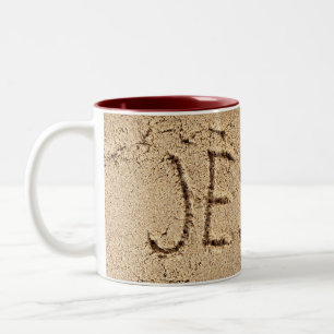 Jesus in beach sand Two-Tone coffee mug