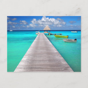 Jetty with boats in a tropical lagoon postcard