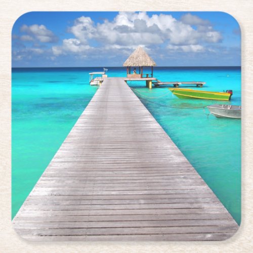Jetty with boats in a tropical lagoon square paper coaster