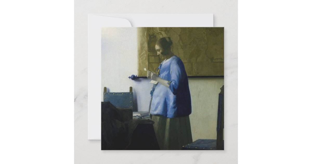 woman in blue reading a letter