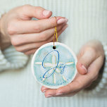 Joy Watercolor Ocean Sand Dollar Seashell Photo Ceramic Ornament<br><div class="desc">Who needs snowflakes when you have seashells! Capture a cool nautical casual and coastal vibe this holiday sea-son with our coastal seaside-inspired holiday Christmas collection. We've hand-painted a beautiful watercolor ocean sand dollar seashell in light turquoise and coastal blue to create a calm coastal vibe to shellabrate the holiday season....</div>
