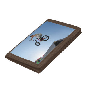 Jumping BMX Against Blue Sky Tri-fold Wallet