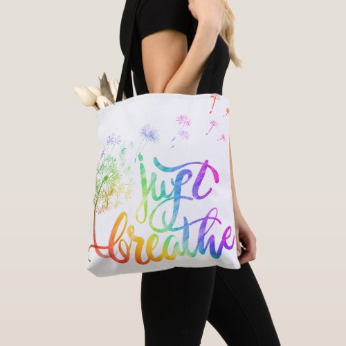 Just breathe   dandelion blowing in the wind  tote bag