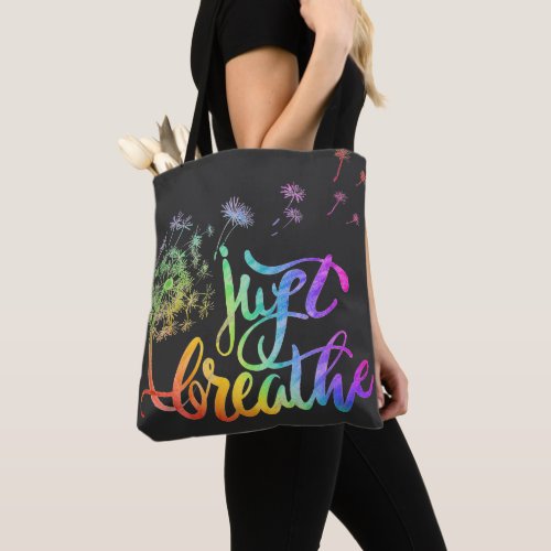 Just breathe   dandelion blowing in the wind  tote bag