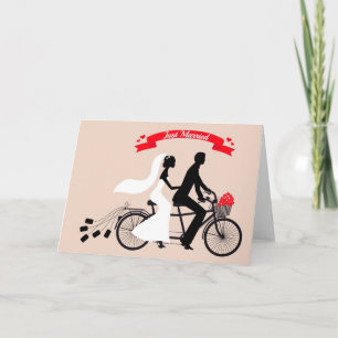 Just married, bride and groom on wedding bicycle announcement