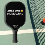 Just One More Game Custom Text Funny Pickleball Paddle<br><div class="desc">We all say it - just one more game - and then we play 5 more ;-) This funny pickleball paddle reads "JUST ONE MORE GAME" in a bold white text that's set against a black background and highlighted by a yellow pickleball (you can easily change the background color). Add...</div>