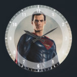 Justice League | Superman On Battlefield Large Clock<br><div class="desc">Check out Justice League's Superman standing on a mist filled,  rocky terrain. The sun rises above the horizon into the blue sky,  causing the mist and clouds to glow bright.</div>