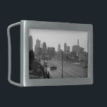 Kansas City Urban Skyline, Black and White Photo Belt Buckle<br><div class="desc">In Kansas City, Missouri, six lane Main Street stretches out from the bottom right corner of the black and white photograph towards the misty skyscraper horizon in the distance. A dark sedan, below and left of center, drives perpendicular to the lanes of traffic creating a moment of intrigue in the...</div>
