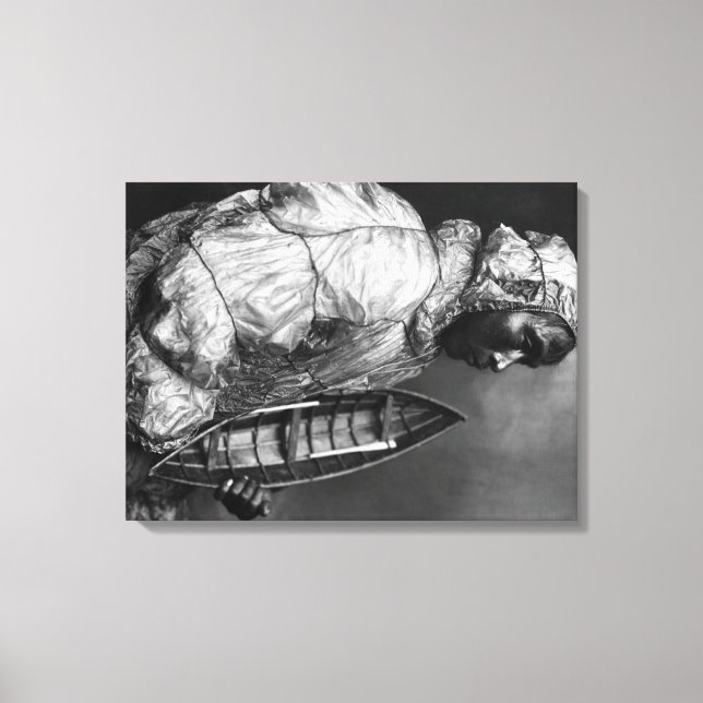 Kayaker wearing water-proof jacket with toy boat canvas print (Front)