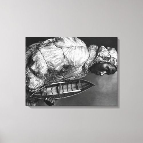 Kayaker wearing water_proof jacket with toy boat canvas print