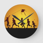 Kids Flying A Kite Round Clock at Zazzle
