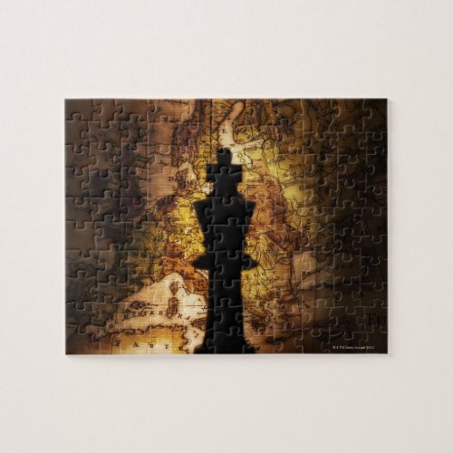 King chess piece on old world map jigsaw puzzle