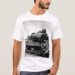 Kwajalein Atoll. Pfc. N.E. Carling stands beside T-Shirt