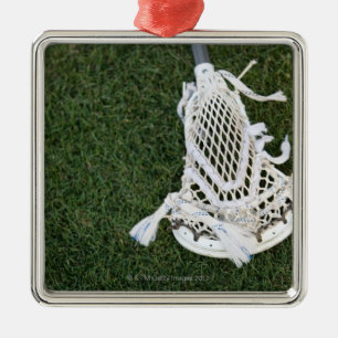 Lacrosse stick on grass metal ornament