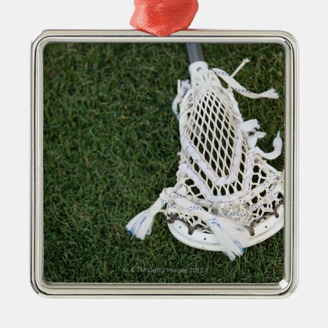 Lacrosse stick on grass metal ornament (Front)