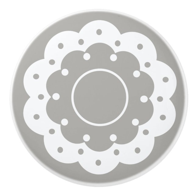 Lacy white cutout doily look on grey ceramic knob (Front)