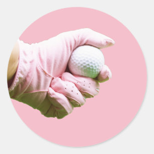 Lady golfer in pink glove is holding golf ball classic round sticker