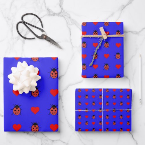 Ladybirds and love hearts on a blue background wrapping paper sheets