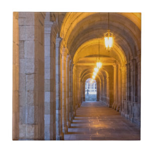 Lamp lit stone hallway, spain tile