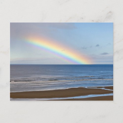 Large rainbow over the Pacific Ocean at Postcard