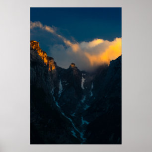 Last breath of sun shining on majestic mountains poster
